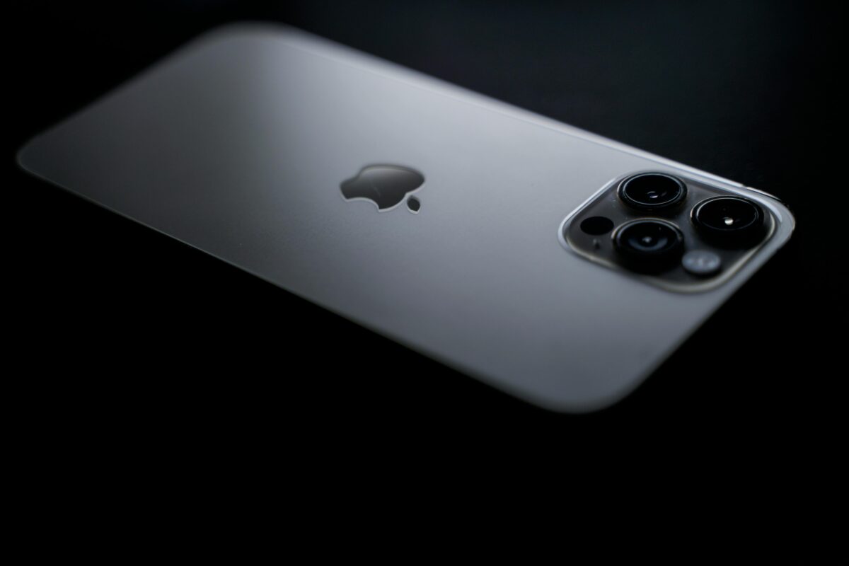 Close-up shot of a sleek smartphone showcasing triple camera lenses on a dark background.