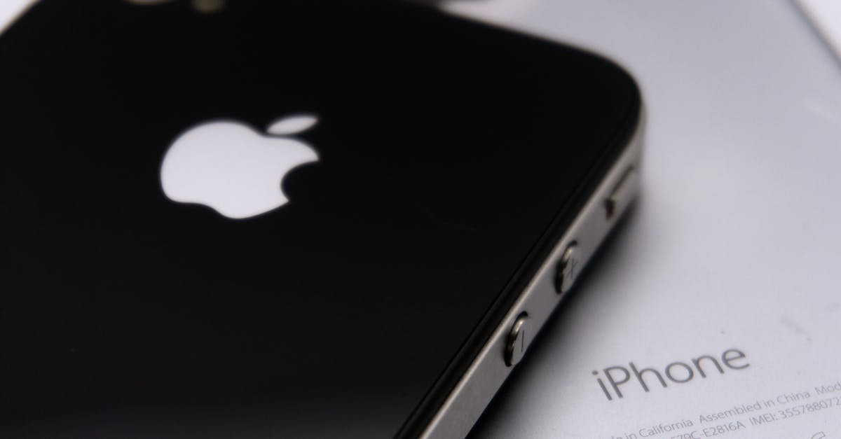 Detailed shot of two smartphones featuring the Apple logo, showcasing modern technology design.
