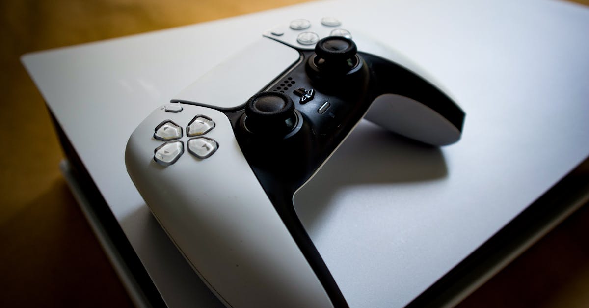 Detailed shot of a PlayStation 5 controller resting on the console, highlighting modern gaming design.