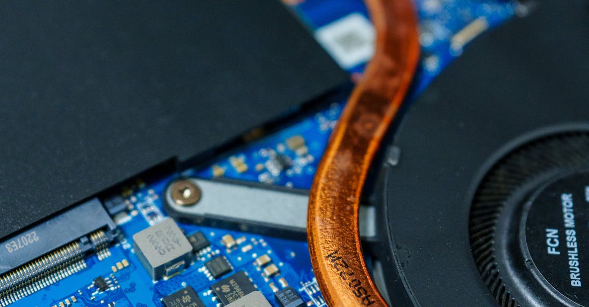 Detailed view of a computer motherboard showcasing heat pipes and internal circuitry.