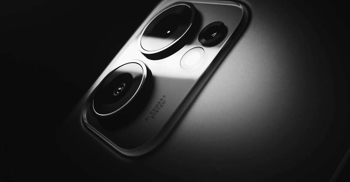Artistic black and white close-up of a smartphone camera lens highlighting its design.