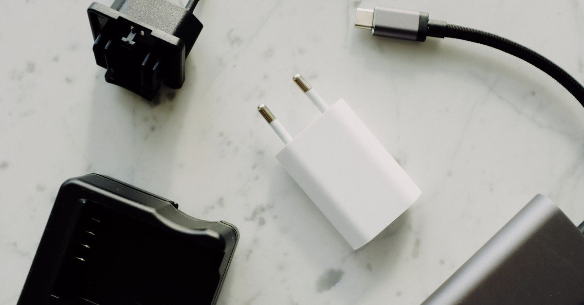 Close-up of USB-C and adaptors on a marble surface, highlighting modern electronics essentials.
