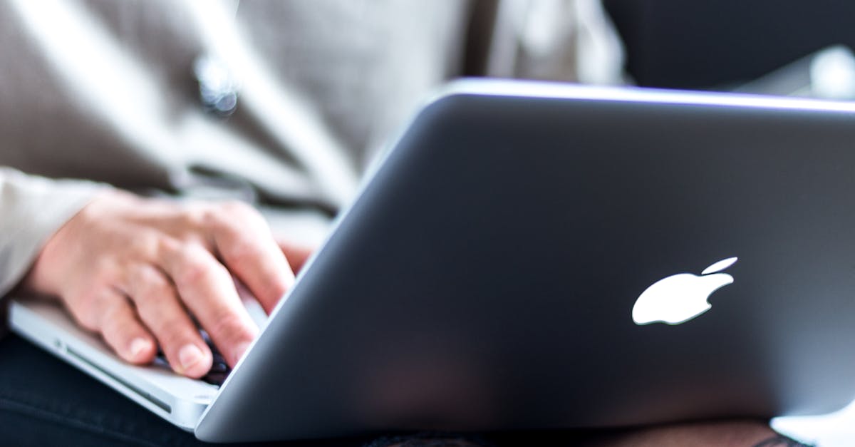 Close-up view of hands typing on a laptop, focusing on technology and remote work.