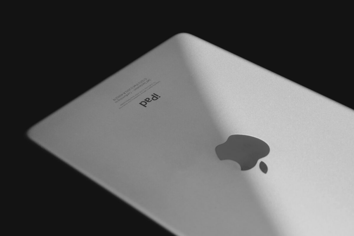 Close-up image of a silver tablet device with a black background, highlighting its sleek design.
