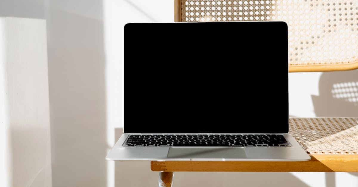 A sleek laptop sitting on a woven chair in a minimalist setting, perfect for modern workspaces.